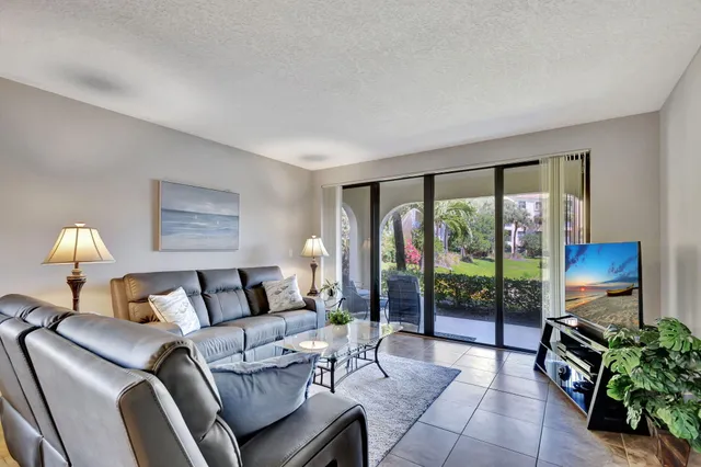 a living room with furniture and a lamp