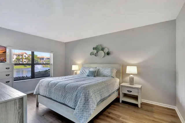 a bed room with a bed window and a television