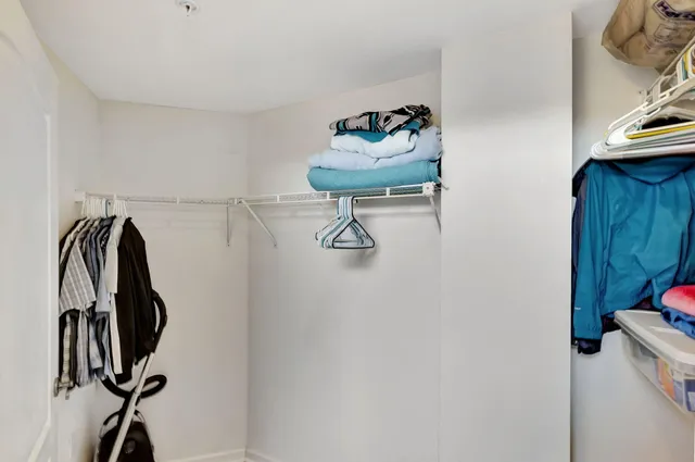 a bedroom with a bed a large window with outer view