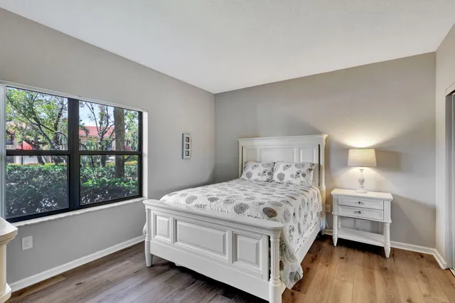 a bedroom with a bed and a mirror