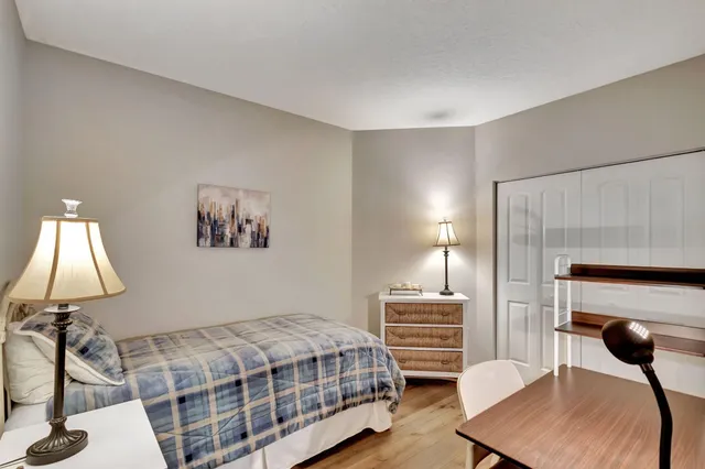 a view of a workspace with furniture and wooden floor