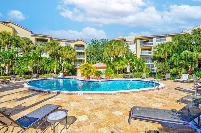 a view of a house with swimming pool and sitting area