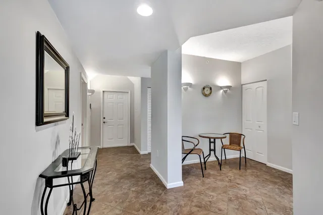 a kitchen with a refrigerator and white cabinets