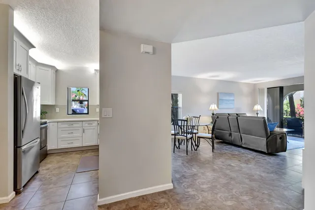 a view of a room with table and chairs