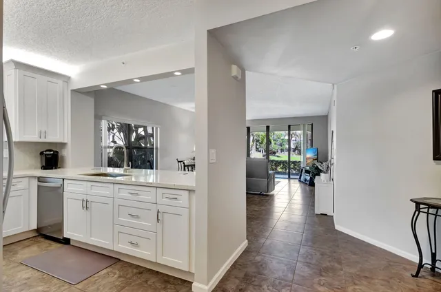 a kitchen with sink and white cabinets
