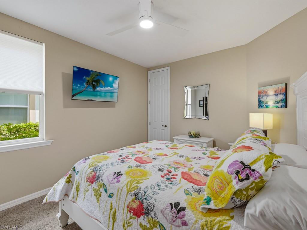 14591 Edgewater Circle Naples, FL 34114 - Photo 11 of 36 Guest Bedroom split plan with carpet and a ceiling fan with light furniture conveys including night stands, and two lamps, tv