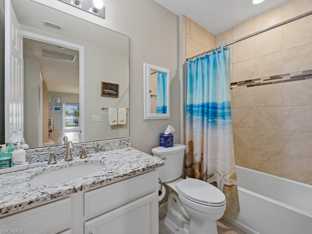 14591 Edgewater Circle Naples, FL 34114 - Photo 12 of 36 Full bathroom with shower / tub combo and vanity