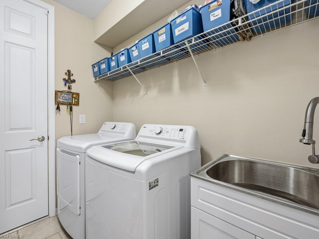 14591 Edgewater Circle Naples, FL 34114 - Photo 14 of 36 Laundry room featuring separate washer and dryer and tile patterned floors