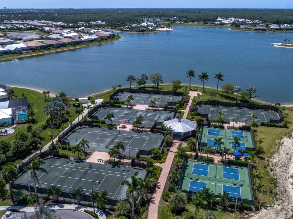 14591 Edgewater Circle Naples, FL 34114 - Photo 24 of 36 Aerial view of tennis and pickleball courts with lake views
