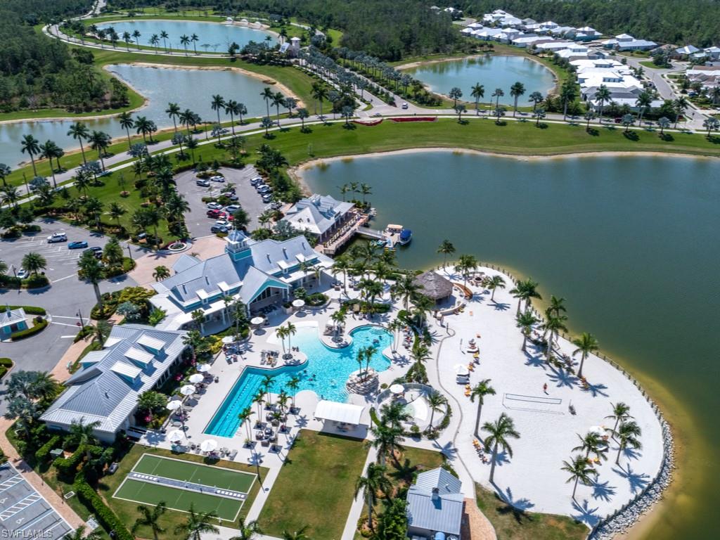 14591 Edgewater Circle Naples, FL 34114 - Photo 28 of 36 Aerial view of the pool, clubhouse and beach area