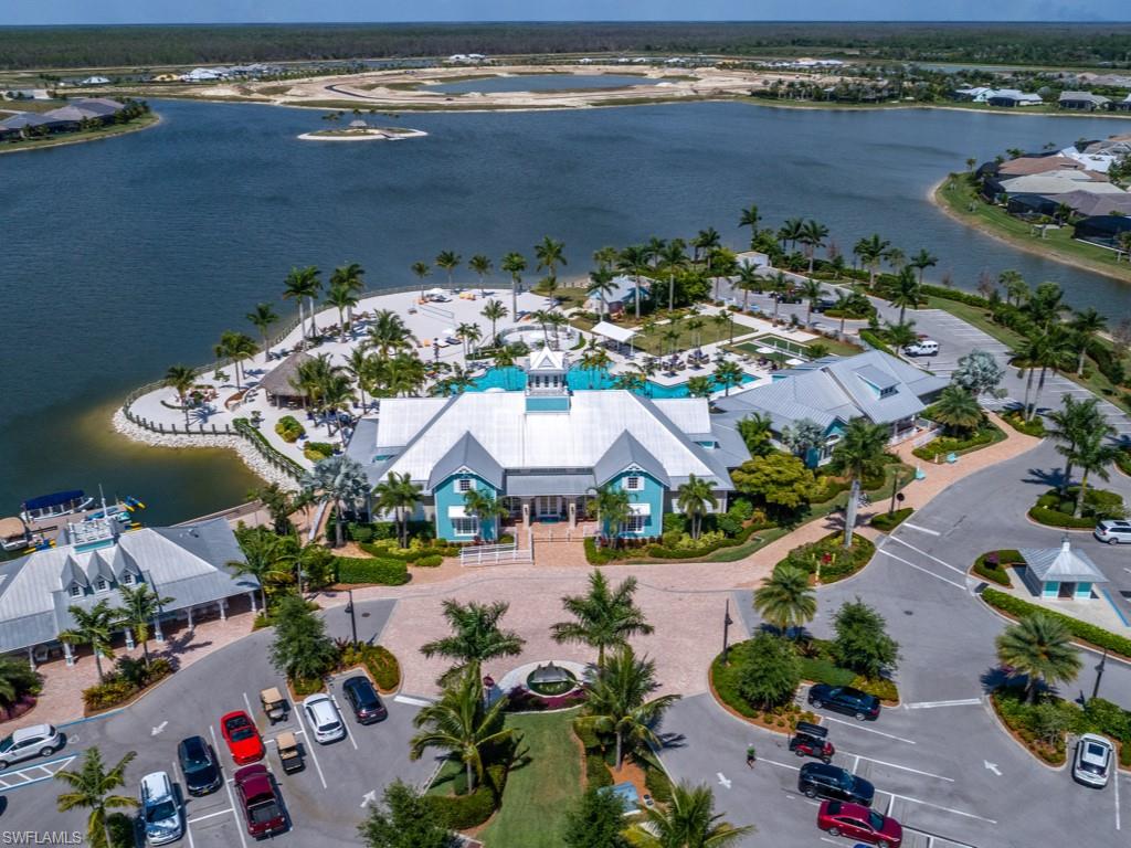 14591 Edgewater Circle Naples, FL 34114 - Photo 34 of 36 Aerial view of the clubhouse with pool on the lake