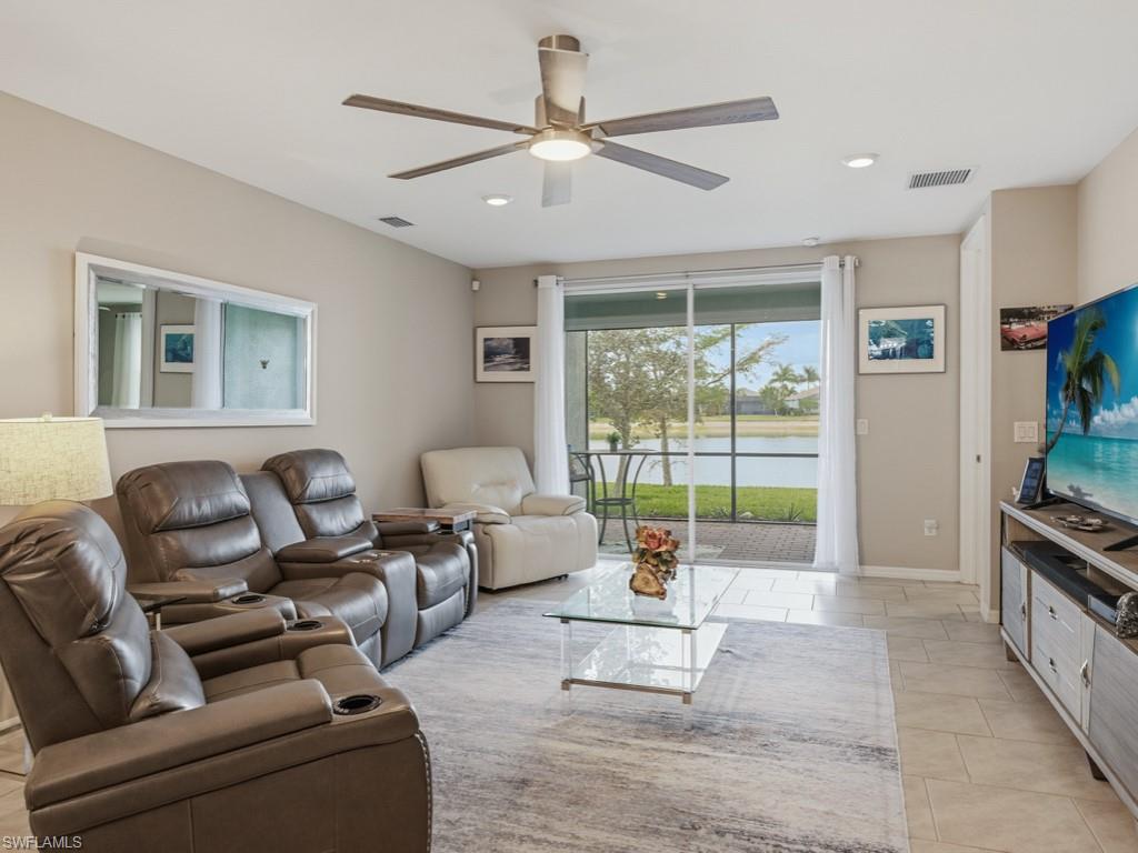 14591 Edgewater Circle Naples, FL 34114 - Photo 4 of 36 Living room with ceiling fan and recessed lighting and view of lake