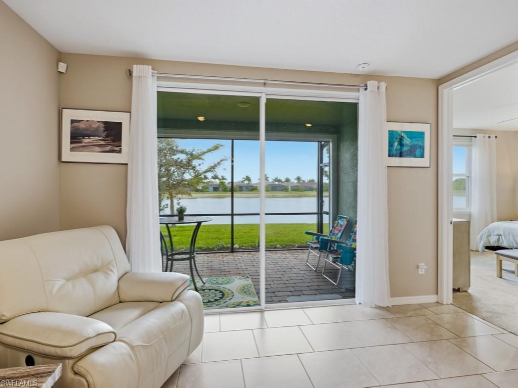 14591 Edgewater Circle Naples, FL 34114 - Photo 7 of 36 Living area featuring a water view and tile patterned floors