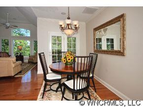 52 Carriage Spring Way Hendersonville, NC 28791 - Photo 4 of 12 a view of a dining room with furniture wooden floor and a chandelier