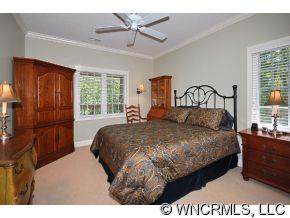 52 Carriage Spring Way Hendersonville, NC 28791 - Photo 8 of 12 a bedroom with a bed mirror and window