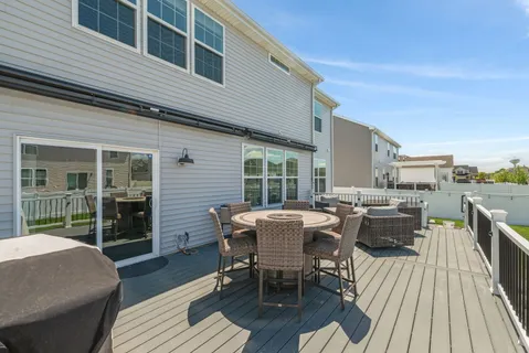 a view of a patio with table and chairs