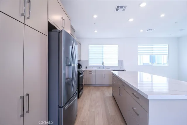 a large white kitchen with a large window