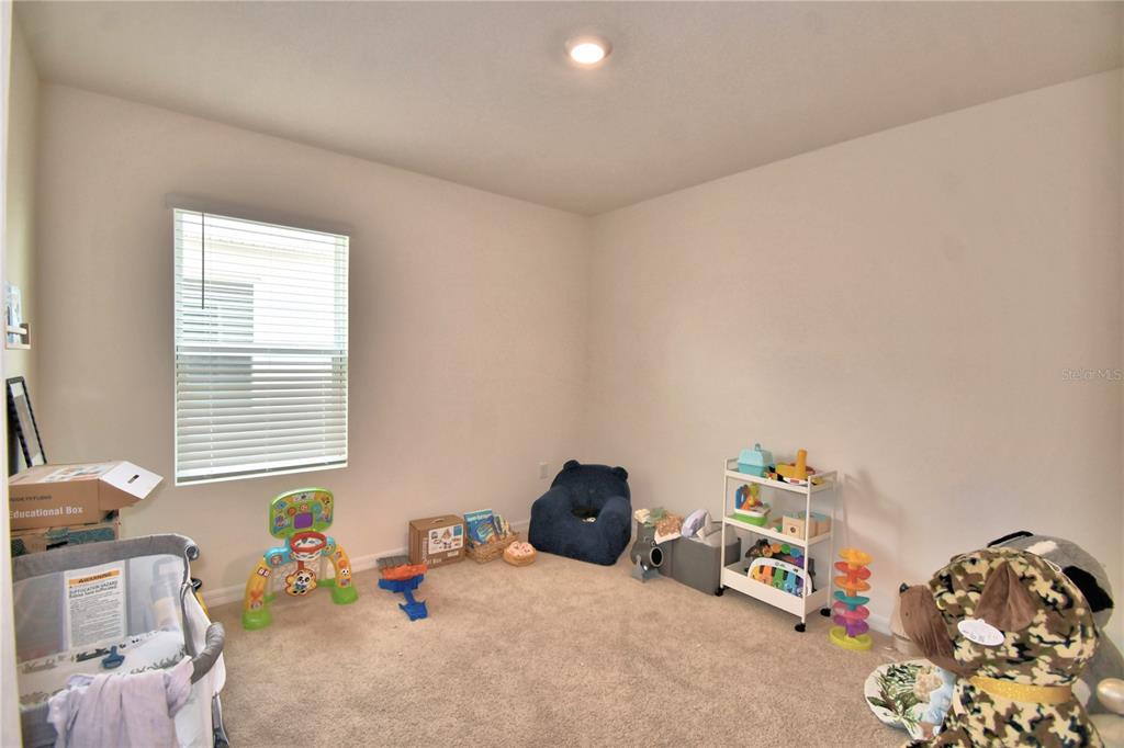 2839 Moulin Road Davenport, FL 33837 - Photo 55 of 75 a bedroom with a bed and a window