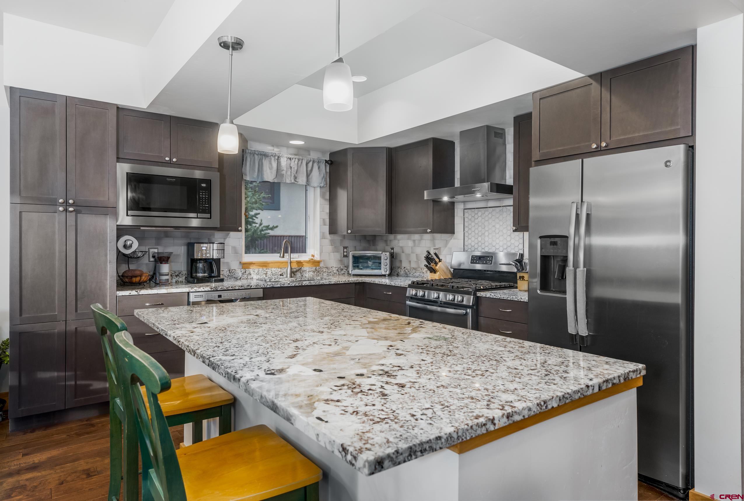 41 Mountain Stream Court Durango, CO 81301 - Photo 18 of 29 a kitchen with stainless steel appliances granite countertop a sink stove and refrigerator