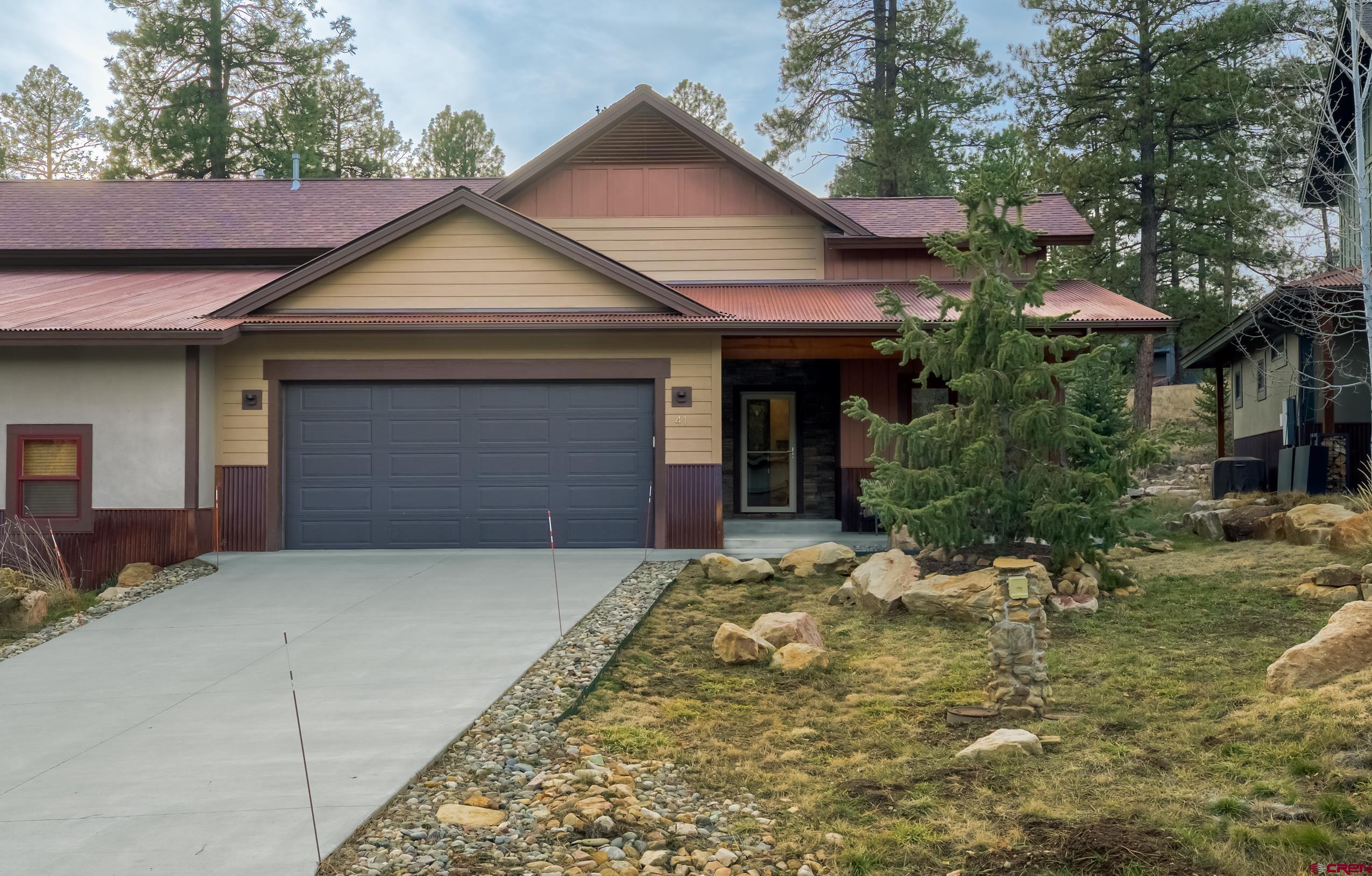 41 Mountain Stream Court Durango, CO 81301 - Photo 24 of 29 a front view of house with yard and trees in the background
