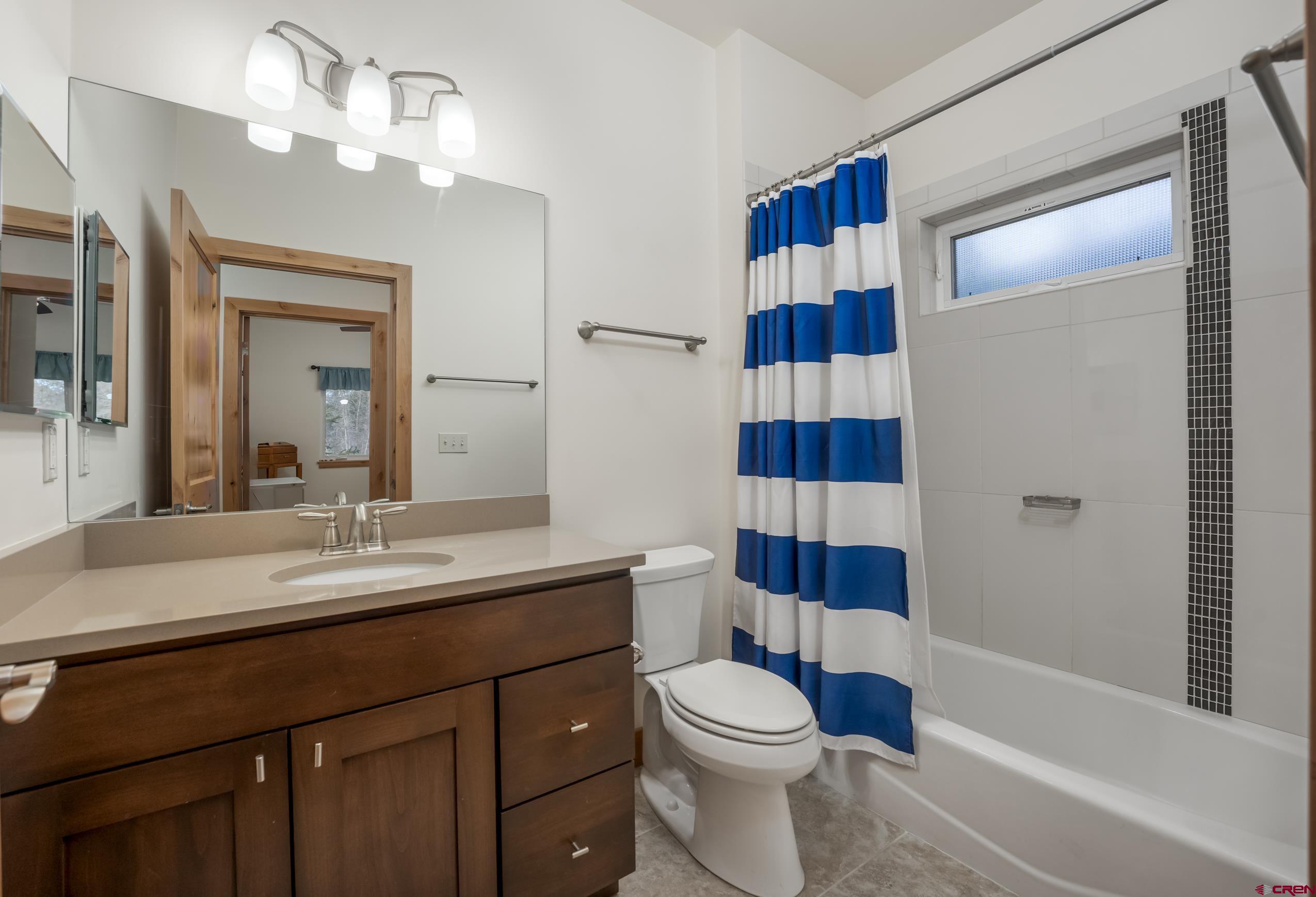 41 Mountain Stream Court Durango, CO 81301 - Photo 4 of 29 a bathroom with a sink a toilet and shower