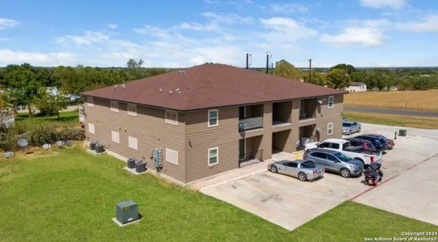 a aerial view of a house with garden space and sitting area