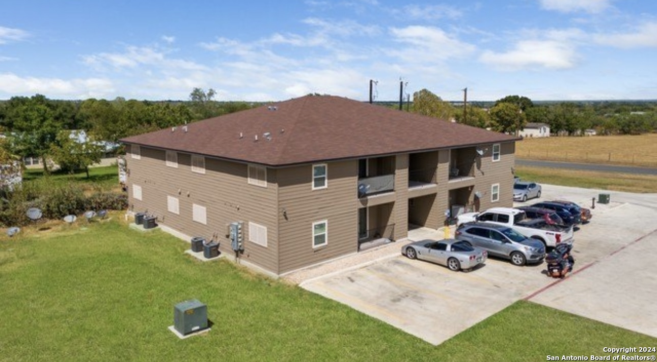 4551 Mt Olive Road, Unit 8 Adkins, TX 78101 - Photo 2 of 8 a aerial view of a house with garden space and sitting area