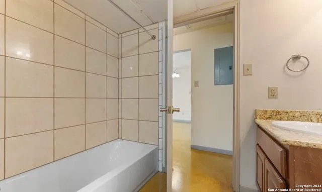 a bathroom with a bathtub and a shower