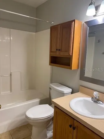 a bathroom with a sink toilet vanity and shower