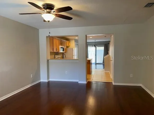 a view of empty room with wooden floor