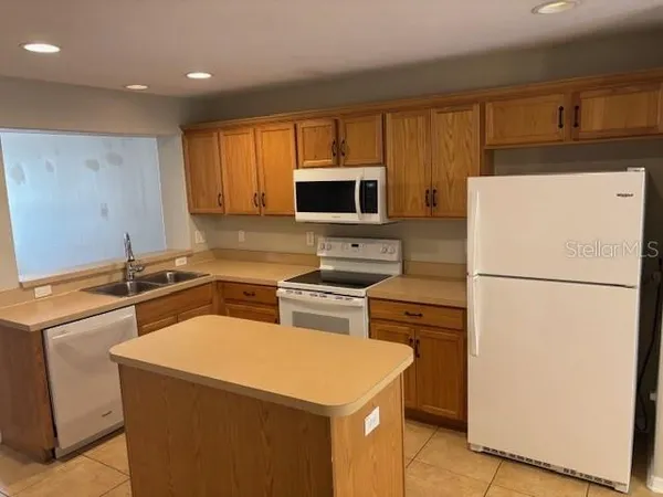 a kitchen with a refrigerator sink and microwave