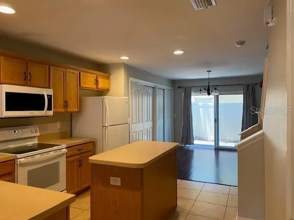 a kitchen that has a sink and a stove in it