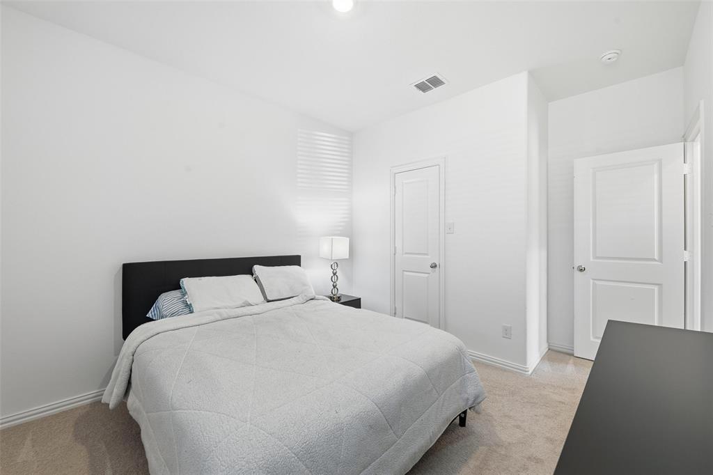 216 Post Oak Street Azle, TX 76020 - Photo 12 of 39 a bedroom with a bed and a night stand