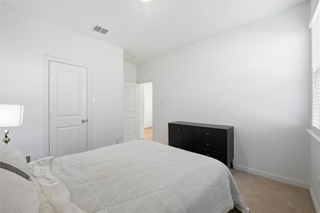 216 Post Oak Street Azle, TX 76020 - Photo 13 of 39 a bedroom with a bed and a closet