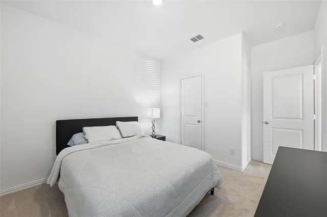 a bedroom with a bed and a night stand