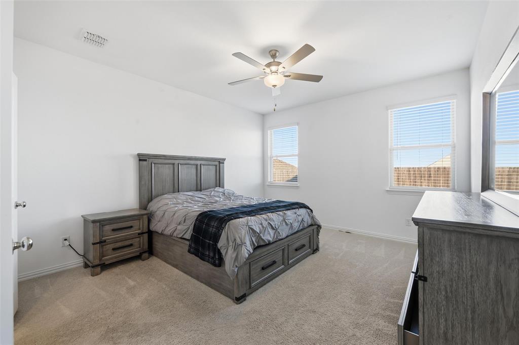 216 Post Oak Street Azle, TX 76020 - Photo 17 of 39 a spacious bedroom with a bed and window