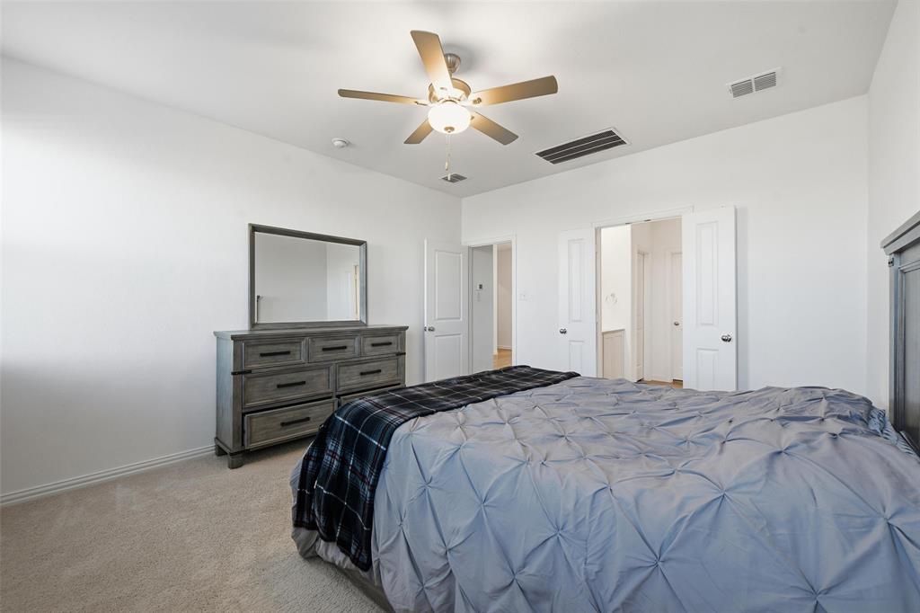 216 Post Oak Street Azle, TX 76020 - Photo 19 of 39 a bedroom with a bed and a chandelier