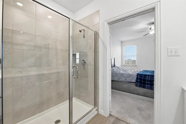 a bathroom with a glass shower door