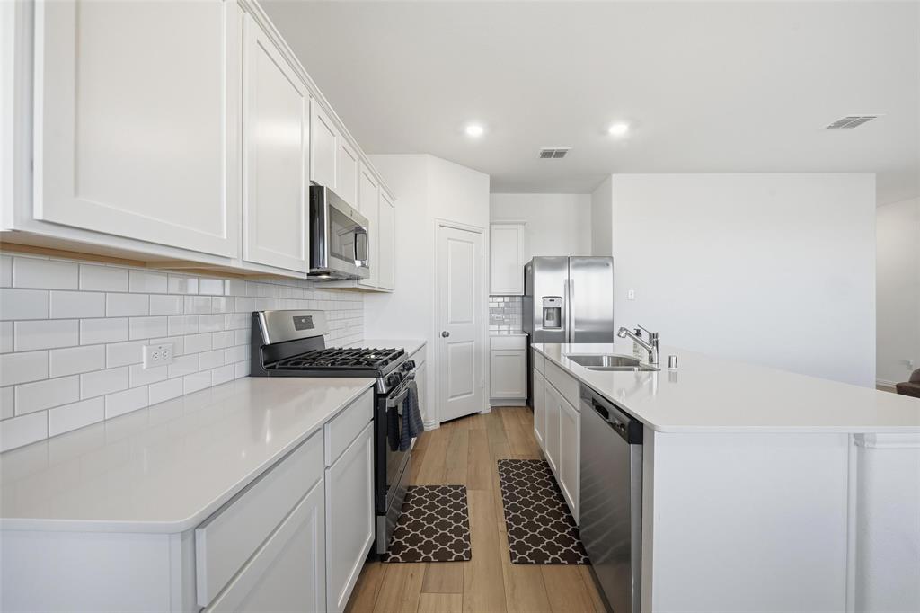 216 Post Oak Street Azle, TX 76020 - Photo 28 of 39 a kitchen with a sink stove and cabinets