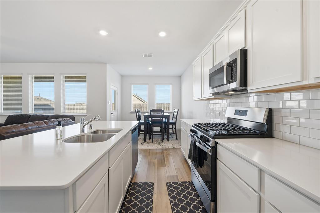216 Post Oak Street Azle, TX 76020 - Photo 30 of 39 a kitchen with granite countertop a sink and stove top oven