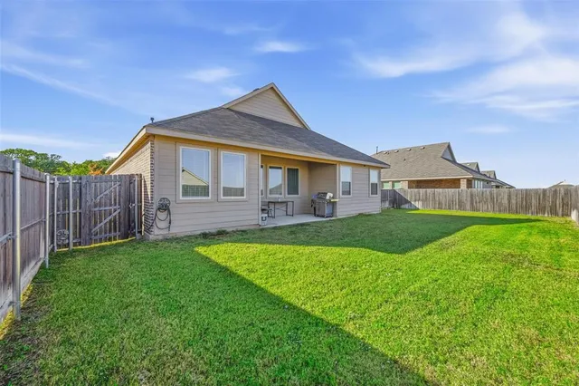 a front view of a house with yard and green space