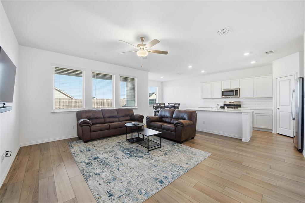 216 Post Oak Street Azle, TX 76020 - Photo 6 of 39 a living room with furniture and kitchen view