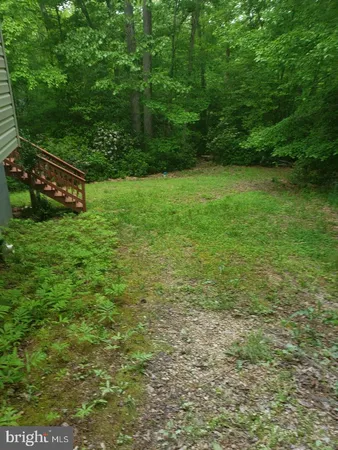 a view of outdoor space with deck and yard