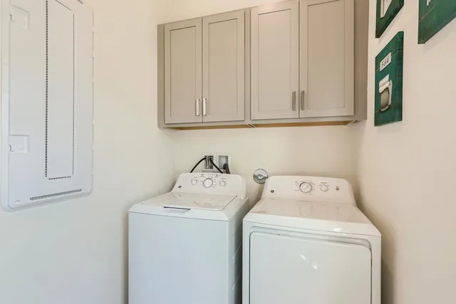 a living room with furniture and a large window with garden view