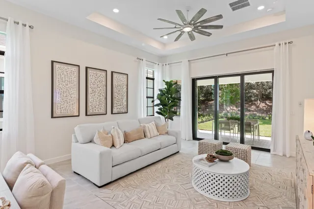 a living room with furniture and large windows