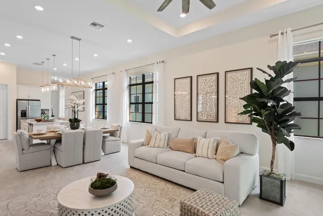 a living room with furniture and kitchen view