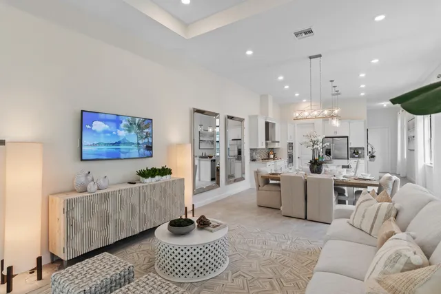 a living room with furniture and a chandelier