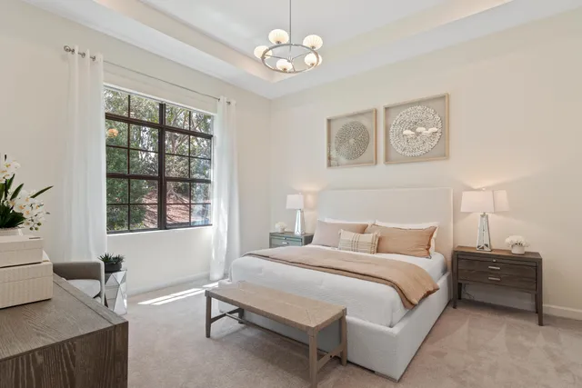 a bedroom with a bed and a chandelier