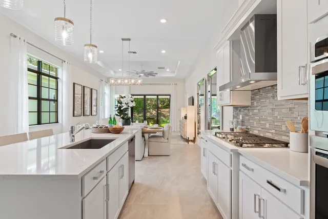 a kitchen that has a lot of cabinets in it and wooden cabinets