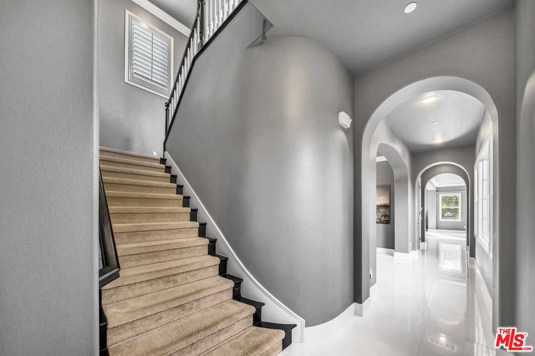 7313 Rocky Top Circle Moorpark, CA 93021 - Photo 11 of 33 a view of a hallway with wooden floor and staircase